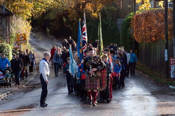 Piper leads village youth on march to memorial