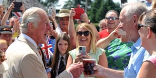 Prince Charles enjoys a pint at the Iddesleigh local and meets War Horse author
