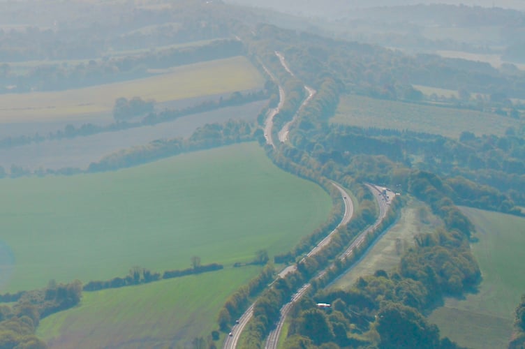 An aerial view looking east along the Hogs Back towards Guildford