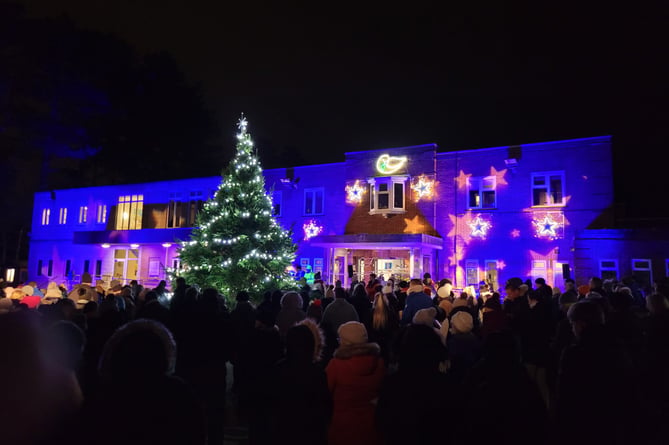 The hospice building was brightly lit with six glowing stars and a dove, as well as with lights and stars