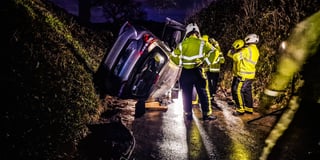 Fire crews help man escape as car ends up on its side