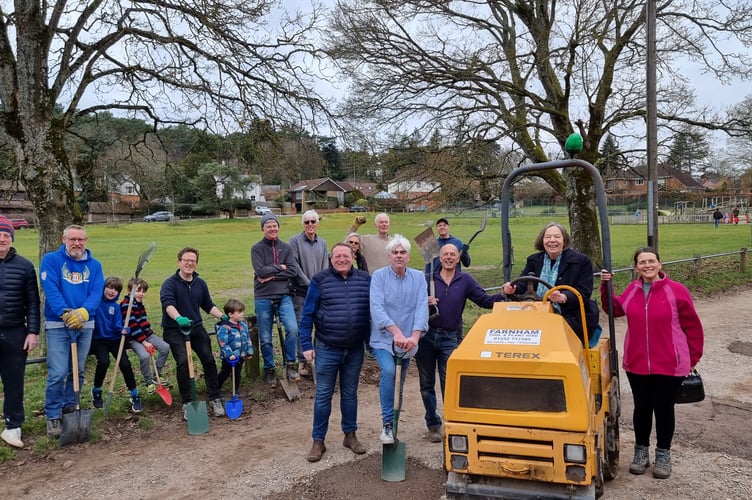 Councillor and Lower Bourne resident Carole Cockburn takes the wheel after neighbours in Dene Lane and Cricket Lane in Lower Bourne filled potholes with 17 tonnes of scalping material