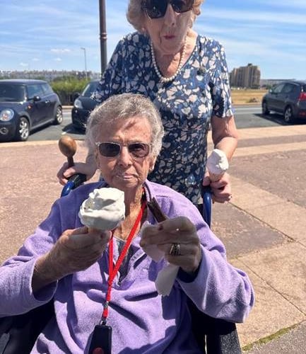 Residents Joan and Jenny enjoy their ice-creams to keep the heat at bay