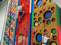 Ukrainian children go up the climbing wall at Alton Sports Centre