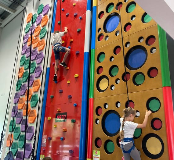 Ukrainian children go up the climbing wall at Alton Sports Centre