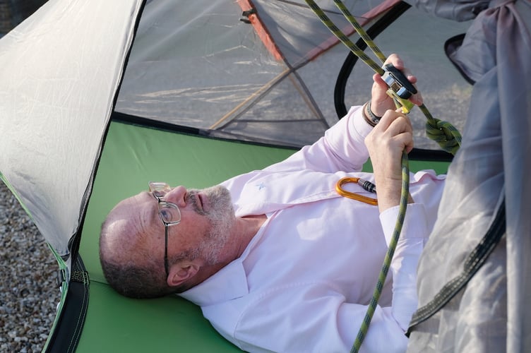 Andrew checking the ropes for his night suspended above the ground.