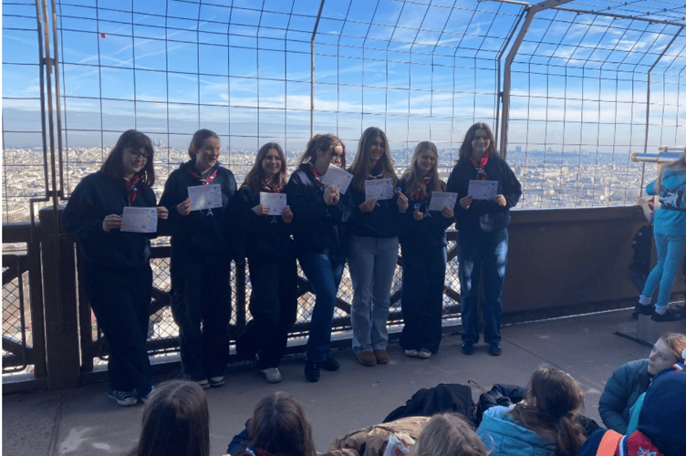 Girl Guides from the 1st Bourne Guiding unit receive their Baden Powell Challenge Awards on top of the Eiffel Tower.