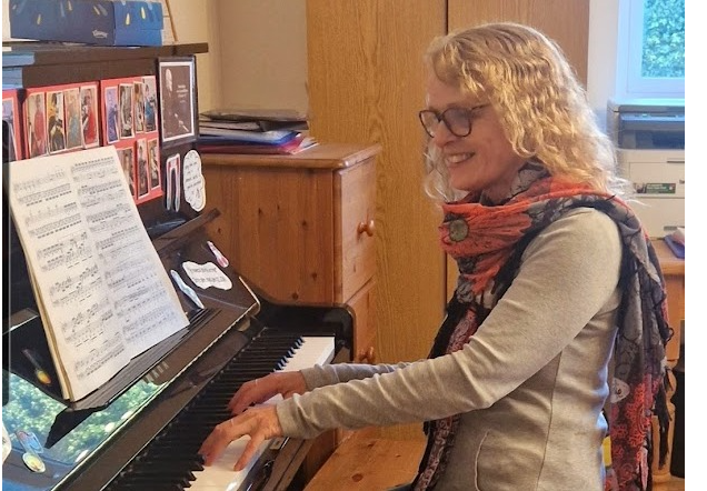 Caroline playing her piano.