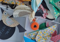 Children make paper crafts with former Surrey Artist of the Year