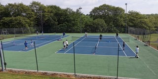 School pupils enjoy playing at tennis club
