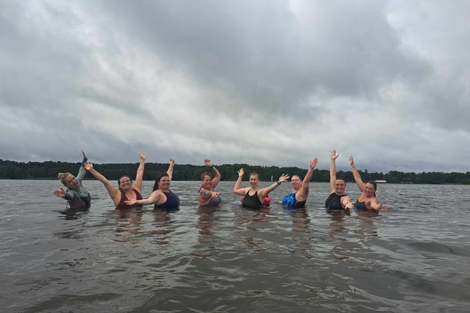 Smiles after a cold water swim at Frensham Great Pond with Mental Health Swims 