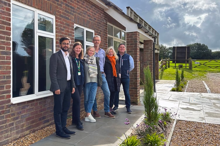 Cllr Adeel Shah (far left) outside Froxfield Village Hall which received £20,000 from the Supporting Communities Fund in 2020 