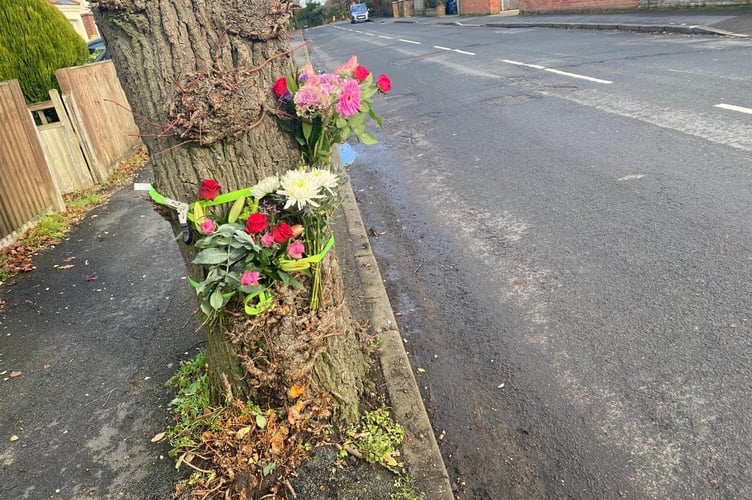 Tributes left at the scene of the collision on Ridgway Road in Farnham